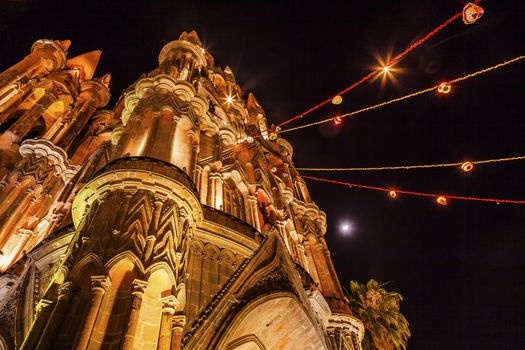 Facade Night Moon Parroquia Christmas Archangel church San Miguel de Allende, Mexico. Parroaguia created in 1600s and facade created in 1880s.

