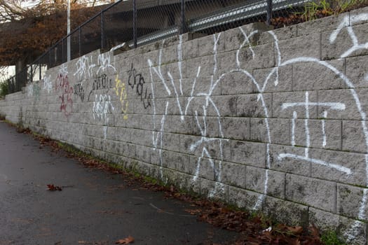 Cement wall with graffiti on it