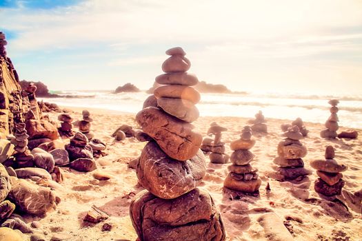 stone balancing at the beach with summer sunlight