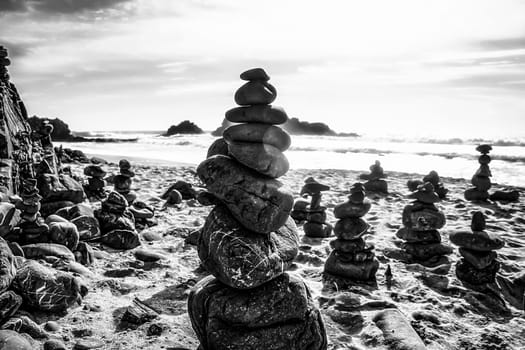 rock balancing at the beach in black and white