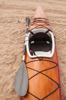 Wooden kayak on sand