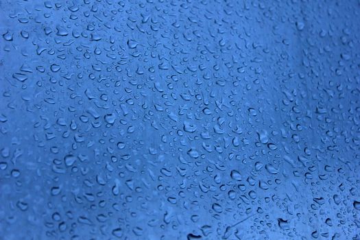 fresh background of water drops on blue surface