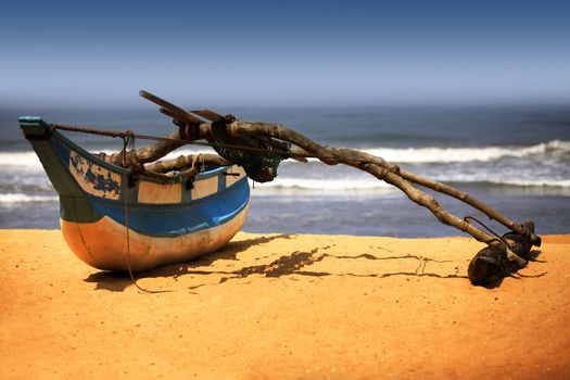 Wooden fishing boat on a sandy beach in sunny day