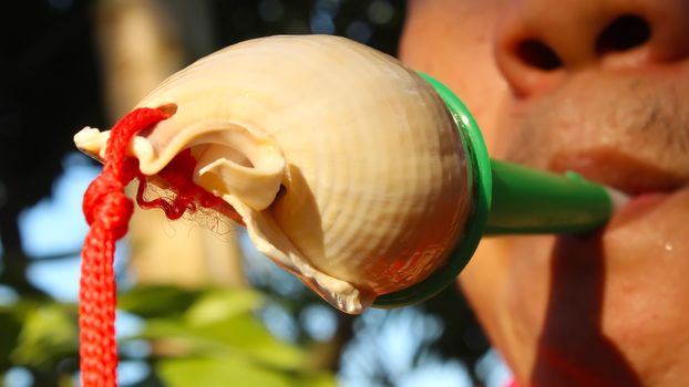 mouth blowing conch