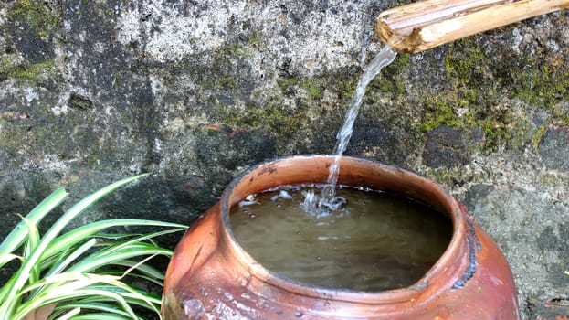 Water flows into the jar