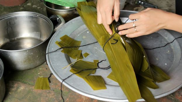 Asian woman packing rice cake