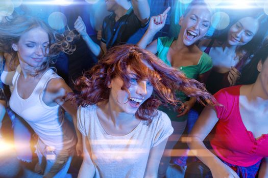 party, holidays, celebration, nightlife and people concept - smiling friends dancing in club