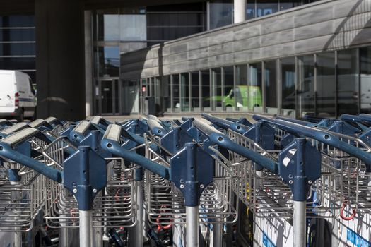 The handles of baggage transporters outside an airport