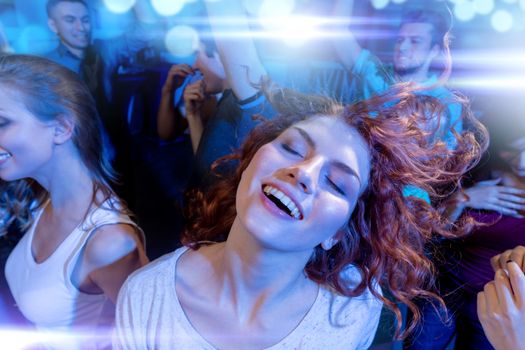 party, holidays, celebration, nightlife and people concept - smiling friends dancing in club