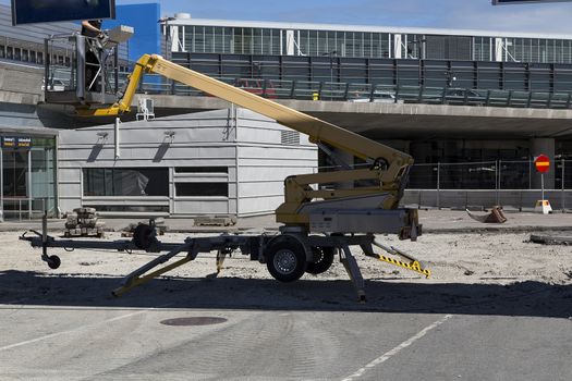 A motorized construction lift for getting persons high up in the air for work