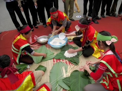 HAI DUONG, VIETNAM, February, 24: People exam to make square glutinous rice cake at Con Son, Kiep Bac festival on February, 24, 2013 in Hai Duong, Vietnam. This cake made with green bean, glutinous rice, fat pork. 