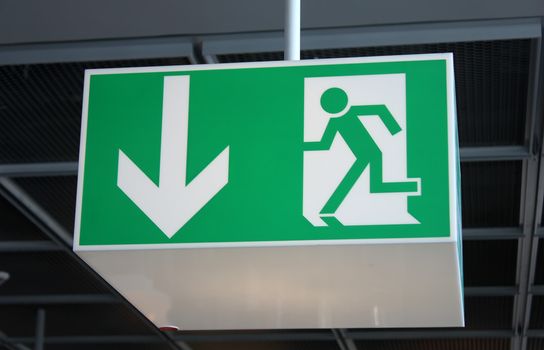 green exit sign attached to the ceiling