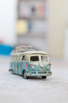 Close up detailed front view of white and blue vintage travel bus toy.