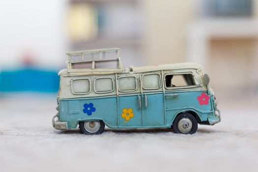 Close up detailed side view of white and blue vintage travel bus toy.
