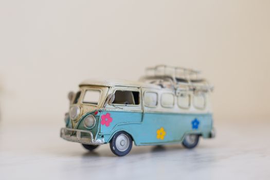 Close up detailed side view of white and blue vintage travel bus toy.