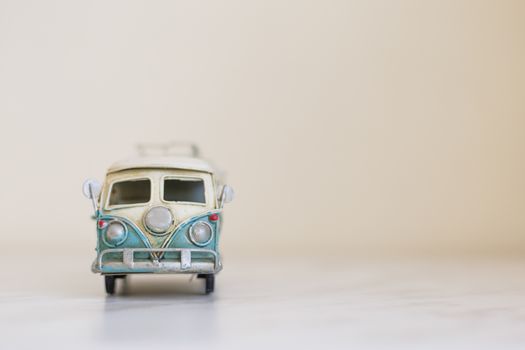 Close up detailed front view of white and blue vintage travel bus toy.