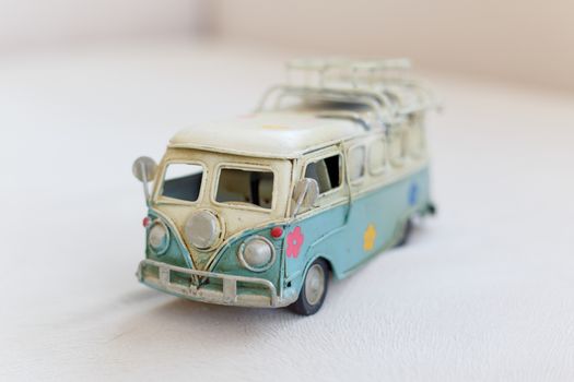 Close up detailed front view of white and blue vintage travel bus toy.