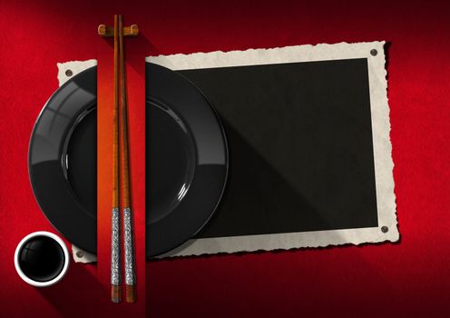 Empty photo frame with black plate, wooden and silver chopsticks, a cup of sauce. Template for an elegant Asian restaurant menu