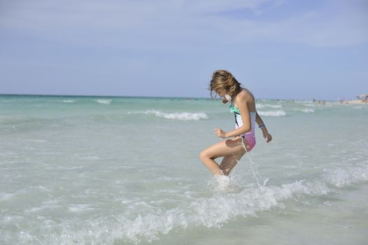 Girl on the Caribbean sunny beach with white sand.