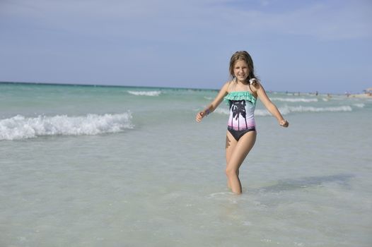 Girl on the Caribbean sunny beach with white sand.