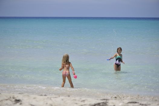 Happy girls have fun in the Caribbean sea.