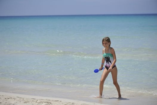happy small girl has fun in the Caribbean sea.