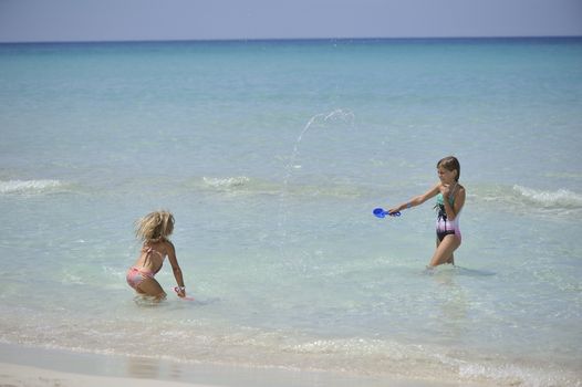 Happy girls have fun in the Caribbean sea.