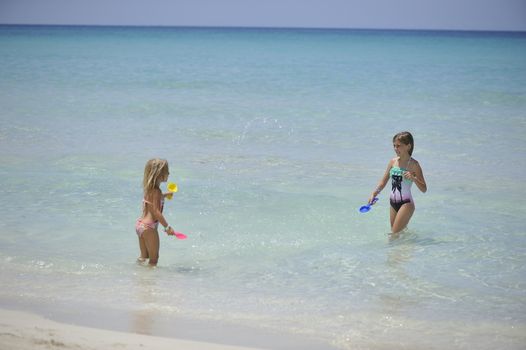 Happy girls have fun in the Caribbean sea.