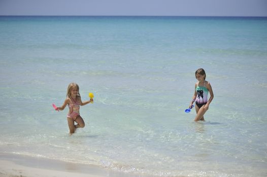 Happy girls have fun in the Caribbean sea.