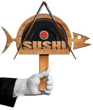 Chef holding a wooden symbol in the shape of fish with black plate, chopsticks, sushi roll and text Sushi. Isolated on white