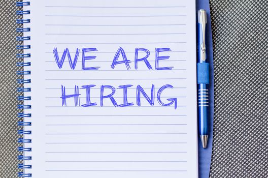 We are hiring text concept write on notebook