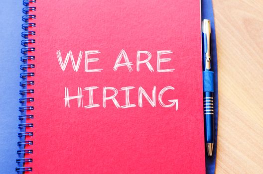 We are hiring text concept write on notebook