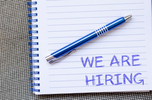 We are hiring text concept write on notebook