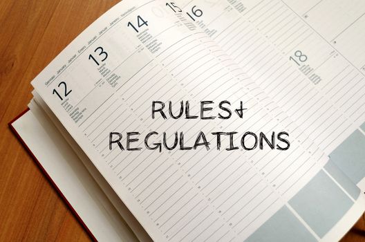 Rules and regulations text concept write on notebook