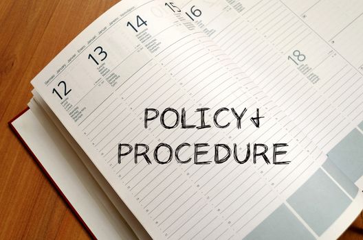 Policy and procedure text concept write on notebook