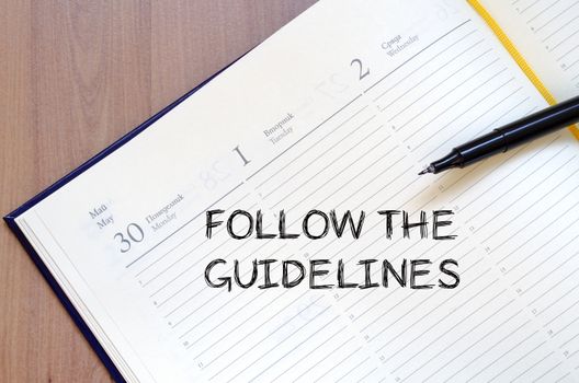 Follow the guidelines text concept write on notebook with pen