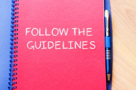 Follow the guidelines text concept write on notebook with pen