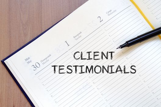 Client testimonials text concept write on notebook with pen