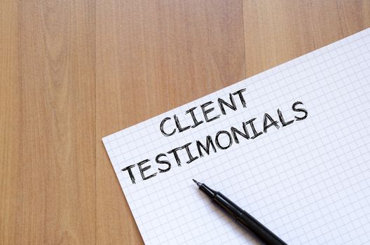 Client testimonials text concept write on notebook with pen