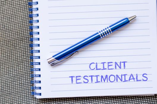 Client testimonials text concept write on notebook with pen