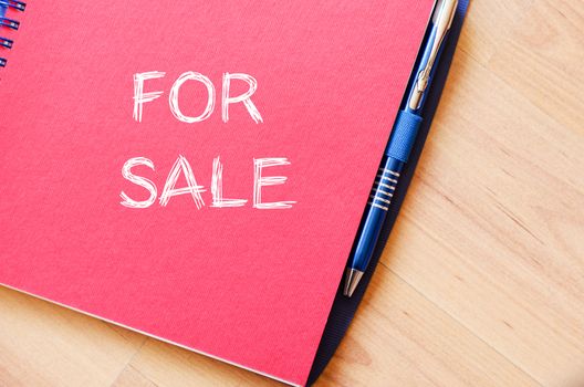 For sale text concept write on notebook with pen