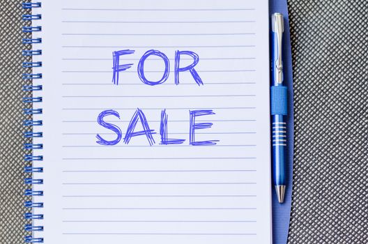 For sale text concept write on notebook with pen