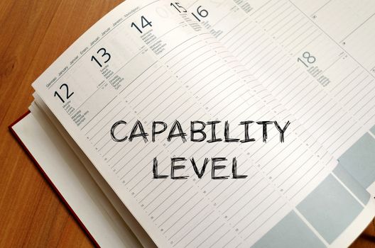 Capability level text concept write on notebook with pen