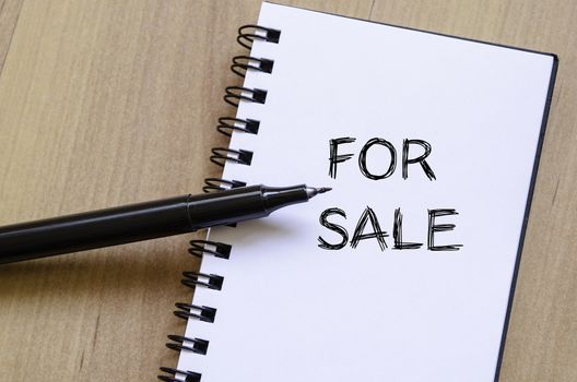 For sale text concept write on notebook with pen