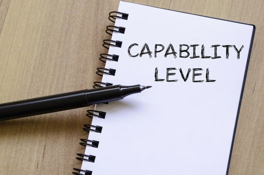 Capability level text concept write on notebook with pen