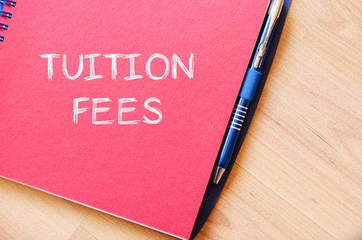 Tuition fees text concept write on notebook with pen