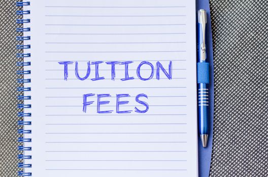Tuition fees text concept write on notebook with pen