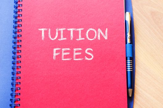 Tuition fees text concept write on notebook with pen