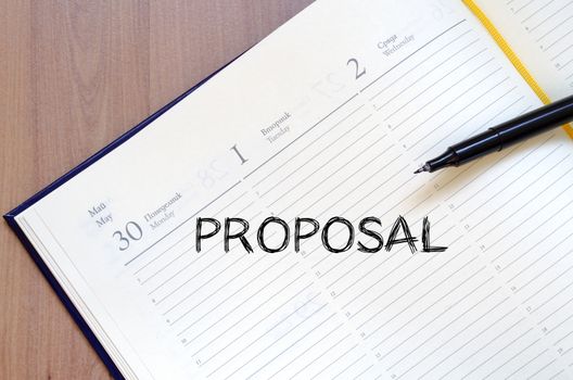 Proposal text concept write on notebook with pen