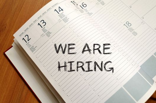 We are hiring text concept write on notebook